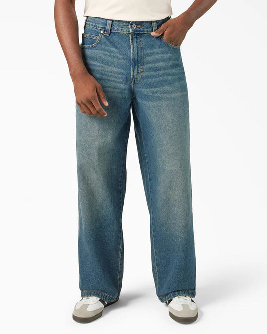 Person wearing blue jeans on a white background